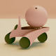 A AI-generated app icon of a space roadster in dusty rose , gray , rose gold , dark green color scheme
