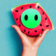 A AI-generated app icon of a smiling face with open hs in watermelon , chambray , melon , red color scheme